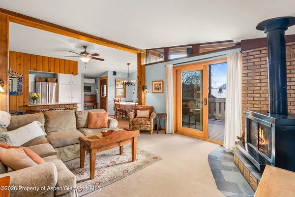 a living room with furniture a large window and a flat screen tv