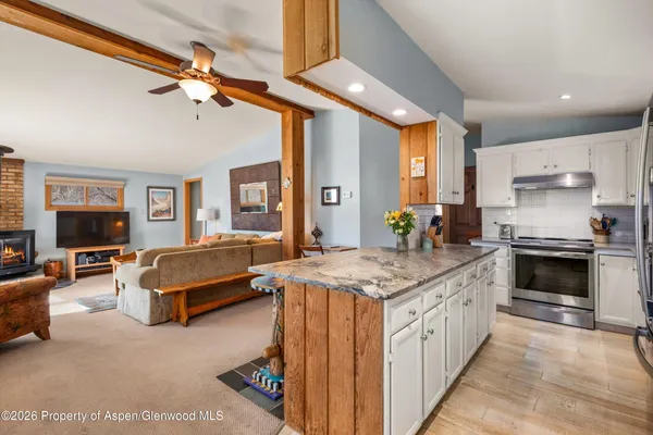 a kitchen with stainless steel appliances granite countertop a stove and a refrigerator
