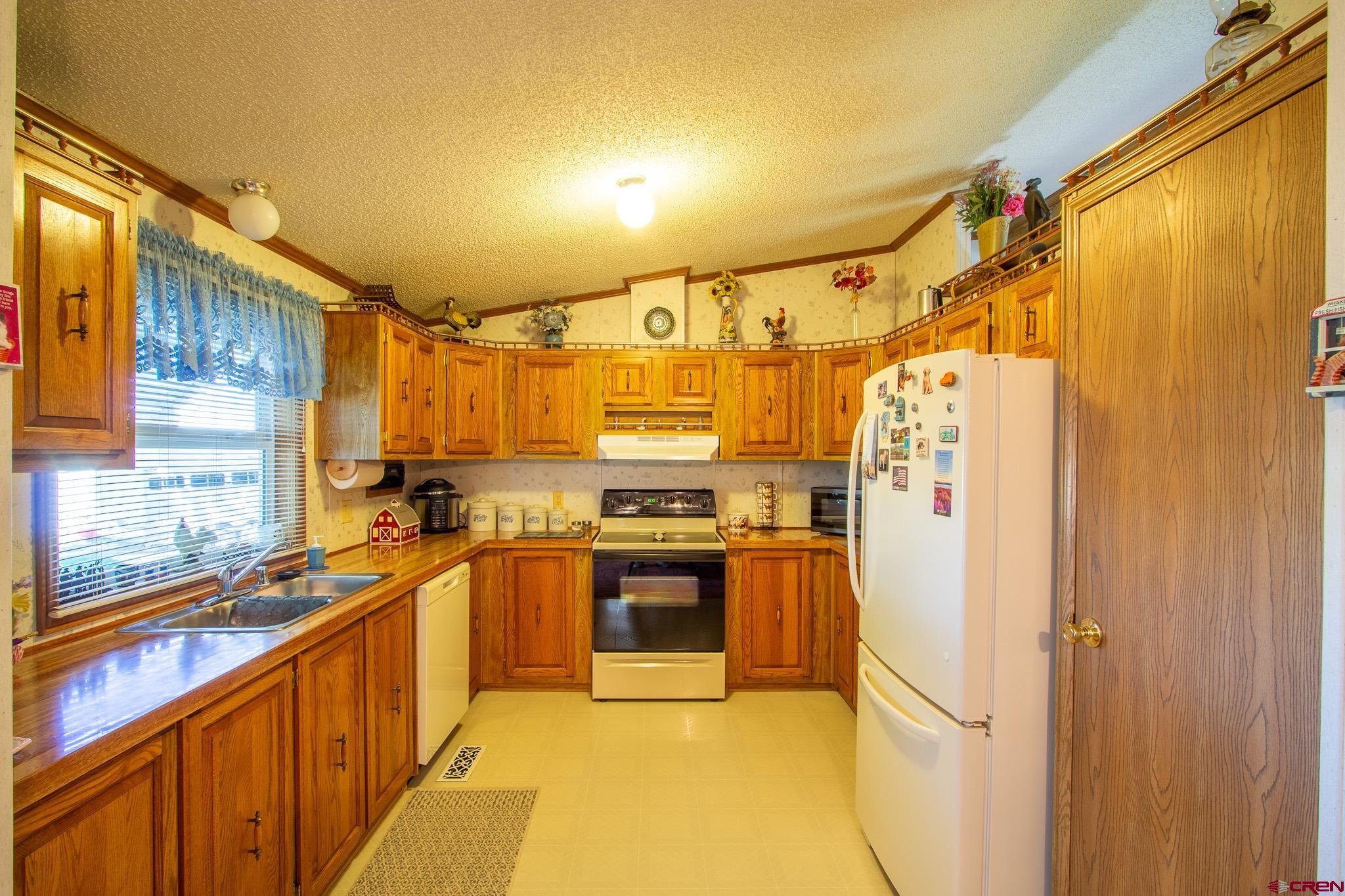 13648 B Road Delta, CO 81416 - Photo 16 of 35 a kitchen with stainless steel appliances a sink and a refrigerator