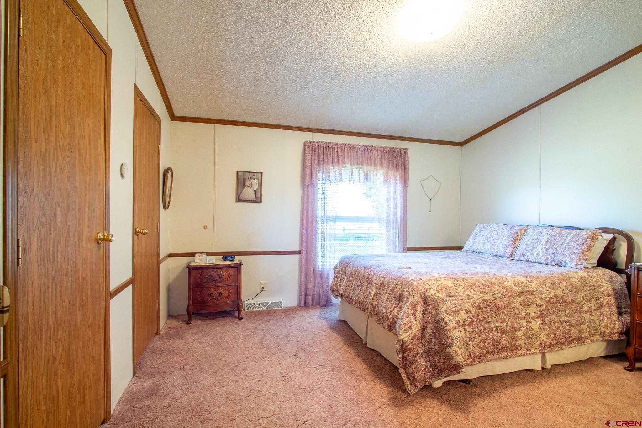 13648 B Road Delta, CO 81416 - Photo 21 of 35 a bedroom with a bed and a dresser