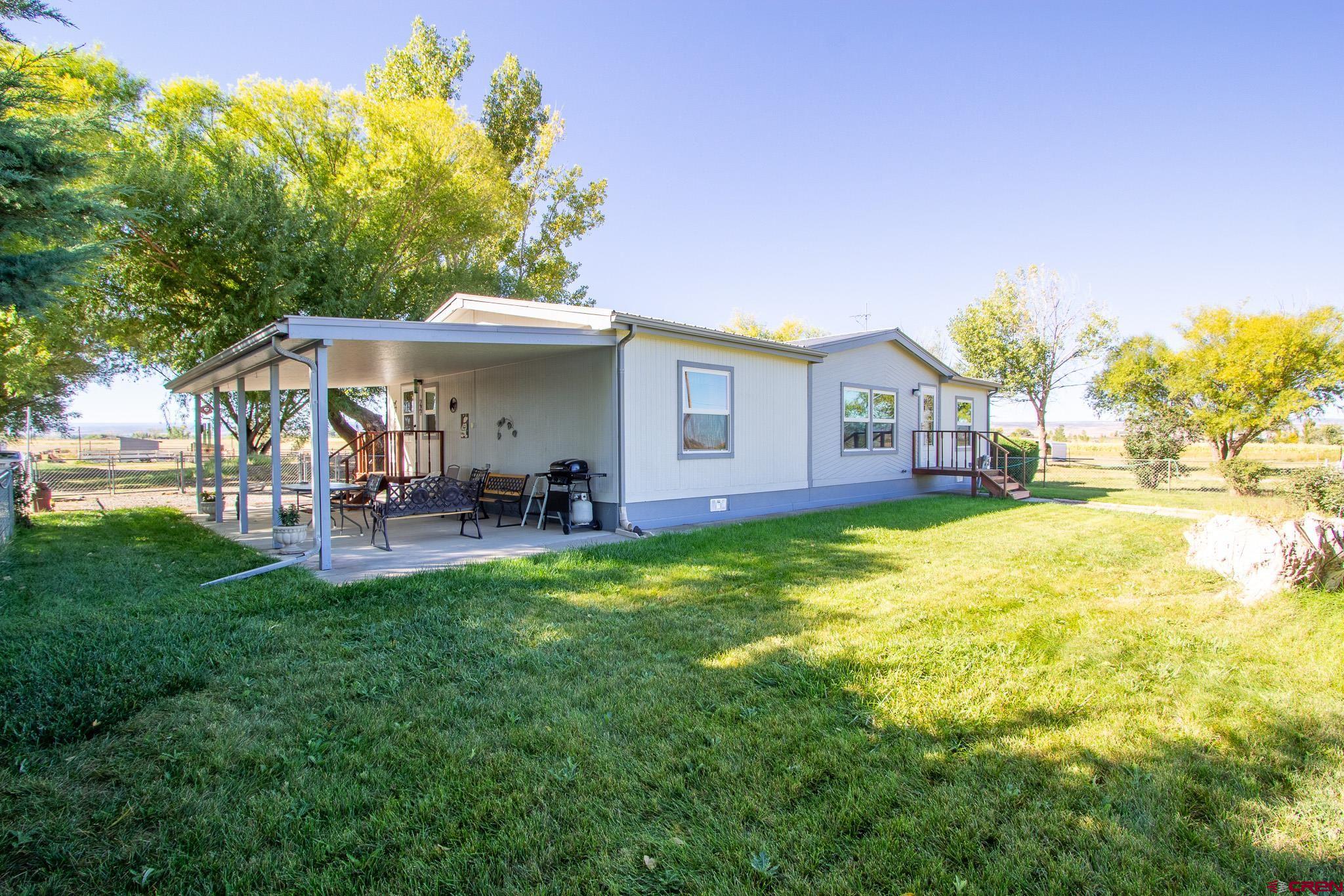 13648 B Road Delta, CO 81416 - Photo 10 of 35 a view of a house with backyard porch and sitting area