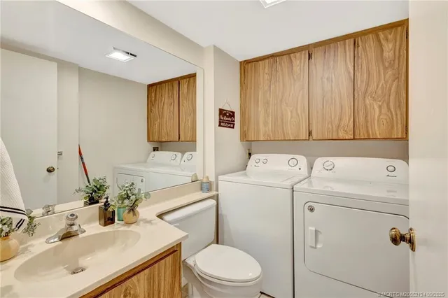 a bathroom with a sink a toilet and vanity