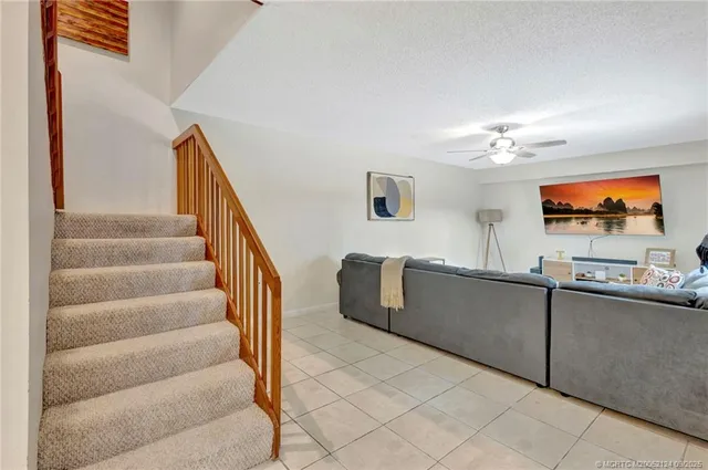 a view of a livingroom with furniture and stairs