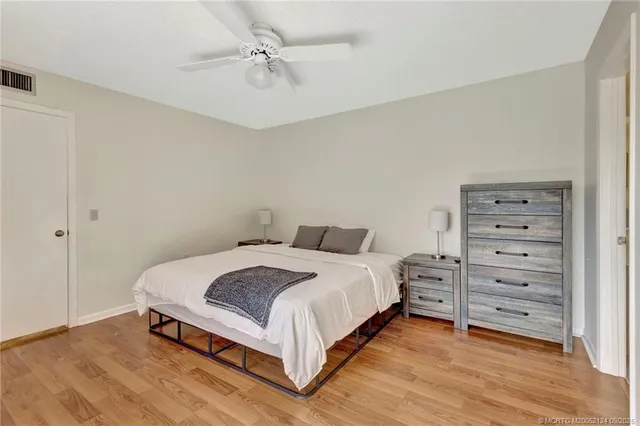 a bedroom with a bed and cabinet