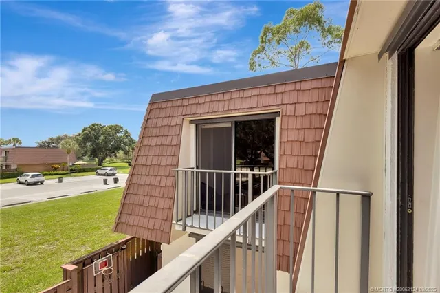 a view of a balcony with lake view and wooden floor