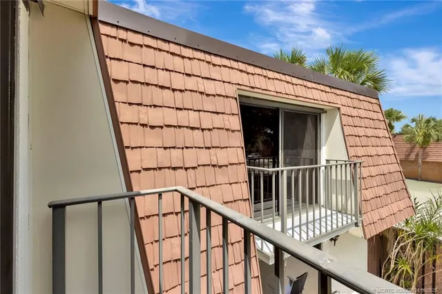 a view of balcony with wooden floor and fence