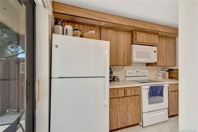 a white refrigerator freezer sitting inside of a kitchen