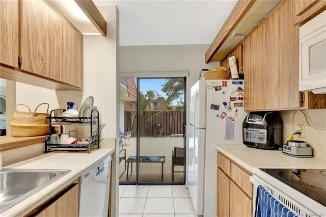 a kitchen with a sink cabinets and appliances