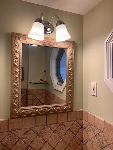 a living room with a stove and a mirror