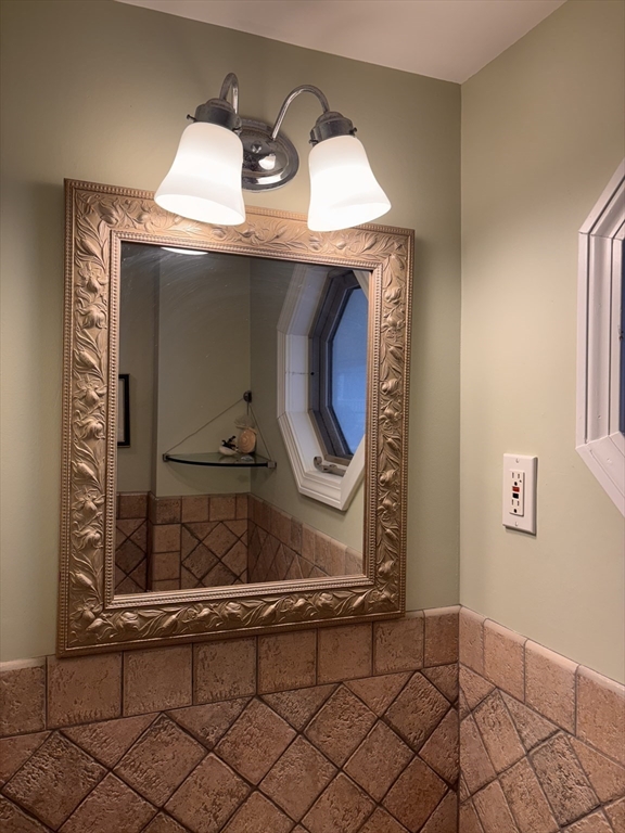 20 Humarock Beach, Unit 1 Scituate, MA 02066 - Photo 15 of 20 a living room with a stove and a mirror