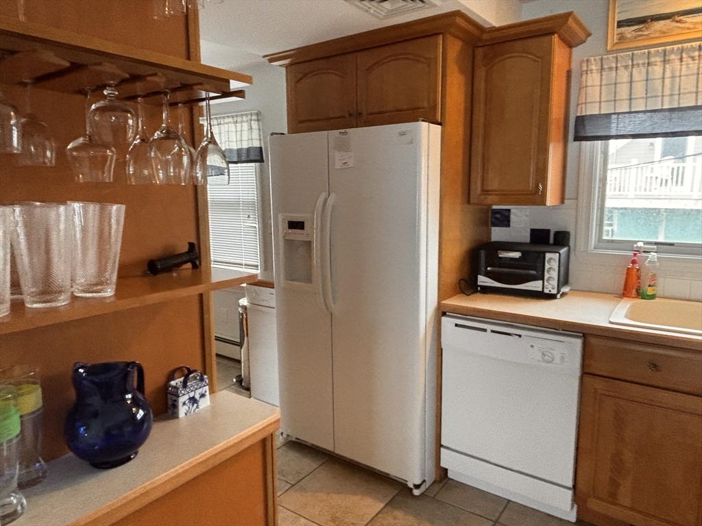 20 Humarock Beach, Unit 1 Scituate, MA 02066 - Photo 2 of 20 a kitchen with stainless steel appliances a refrigerator and a sink