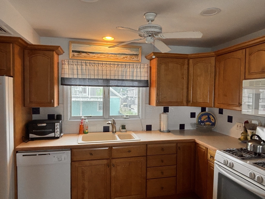 20 Humarock Beach, Unit 1 Scituate, MA 02066 - Photo 3 of 20 a kitchen with a sink stove and cabinets