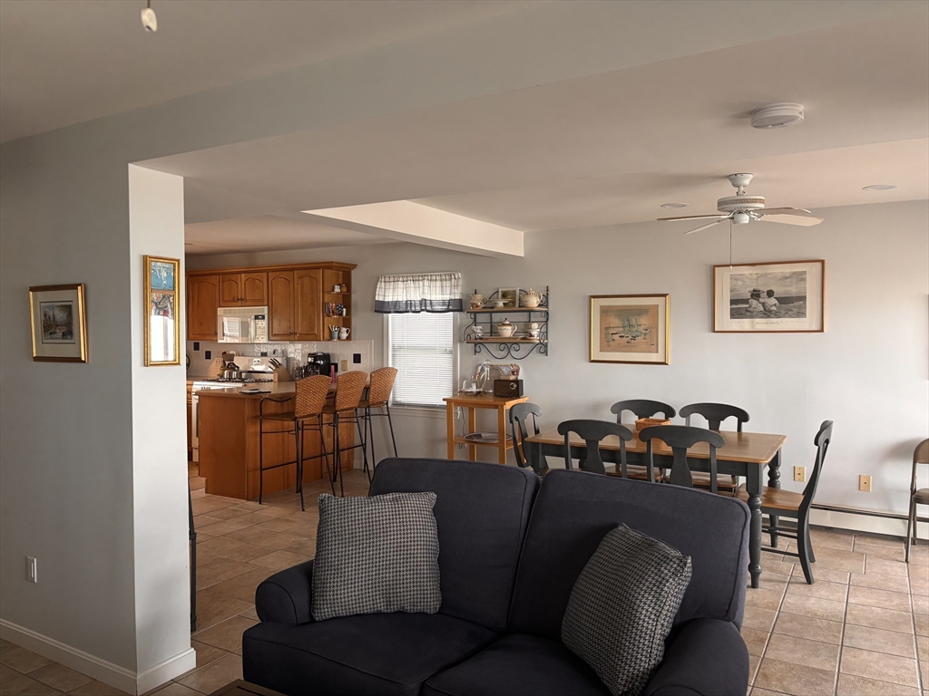 20 Humarock Beach, Unit 1 Scituate, MA 02066 - Photo 4 of 20 a living room with furniture kitchen view and a wooden floor