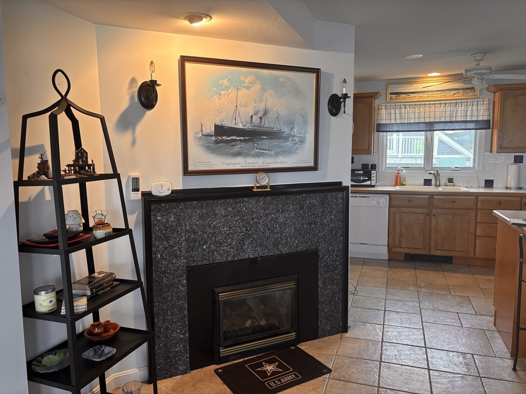 20 Humarock Beach, Unit 1 Scituate, MA 02066 - Photo 5 of 20 a kitchen with windows and a fireplace
