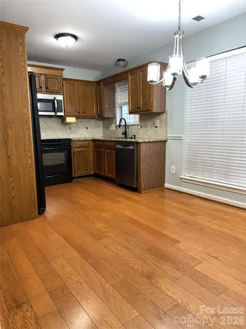 a kitchen with a sink cabinets and window