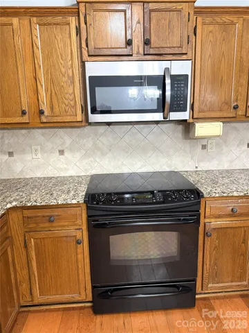 a stove top oven sitting inside of a kitchen