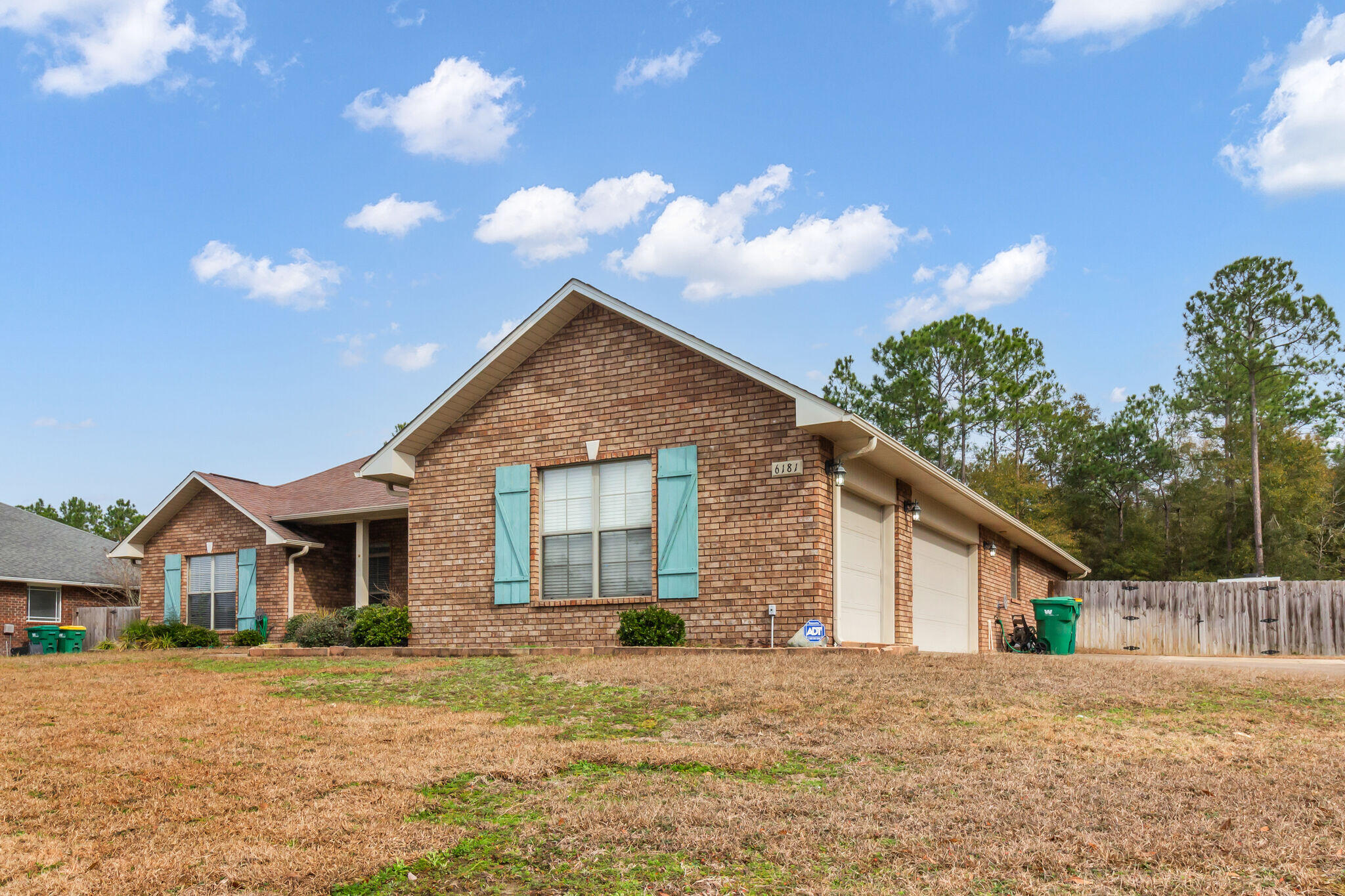 6181 Hummingbird Lane Crestview, FL 32536 - Photo 2 of 46 a front view of a house with a yard and garage