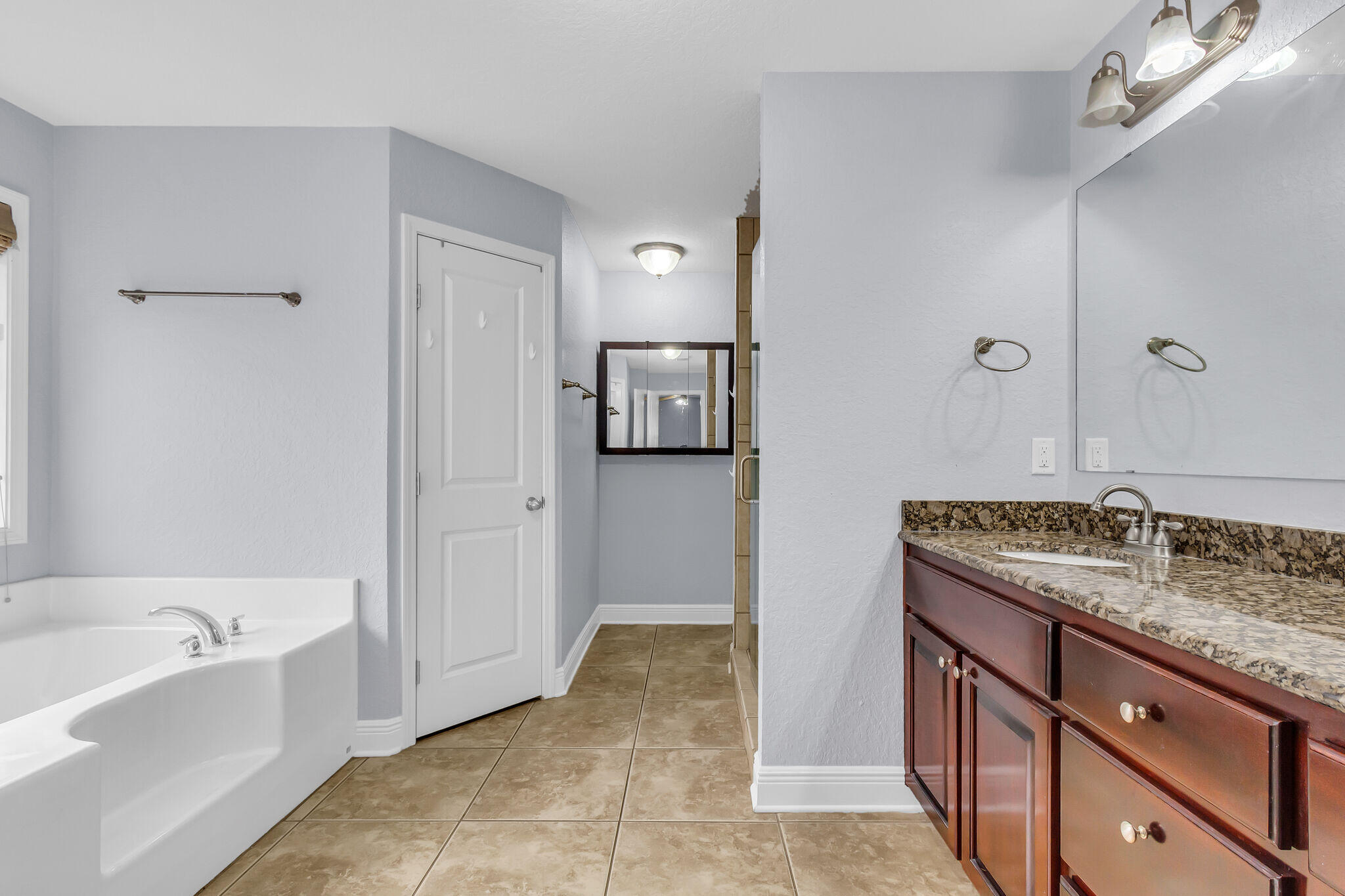 6181 Hummingbird Lane Crestview, FL 32536 - Photo 28 of 46 a bathroom with a granite countertop tub sink and mirror