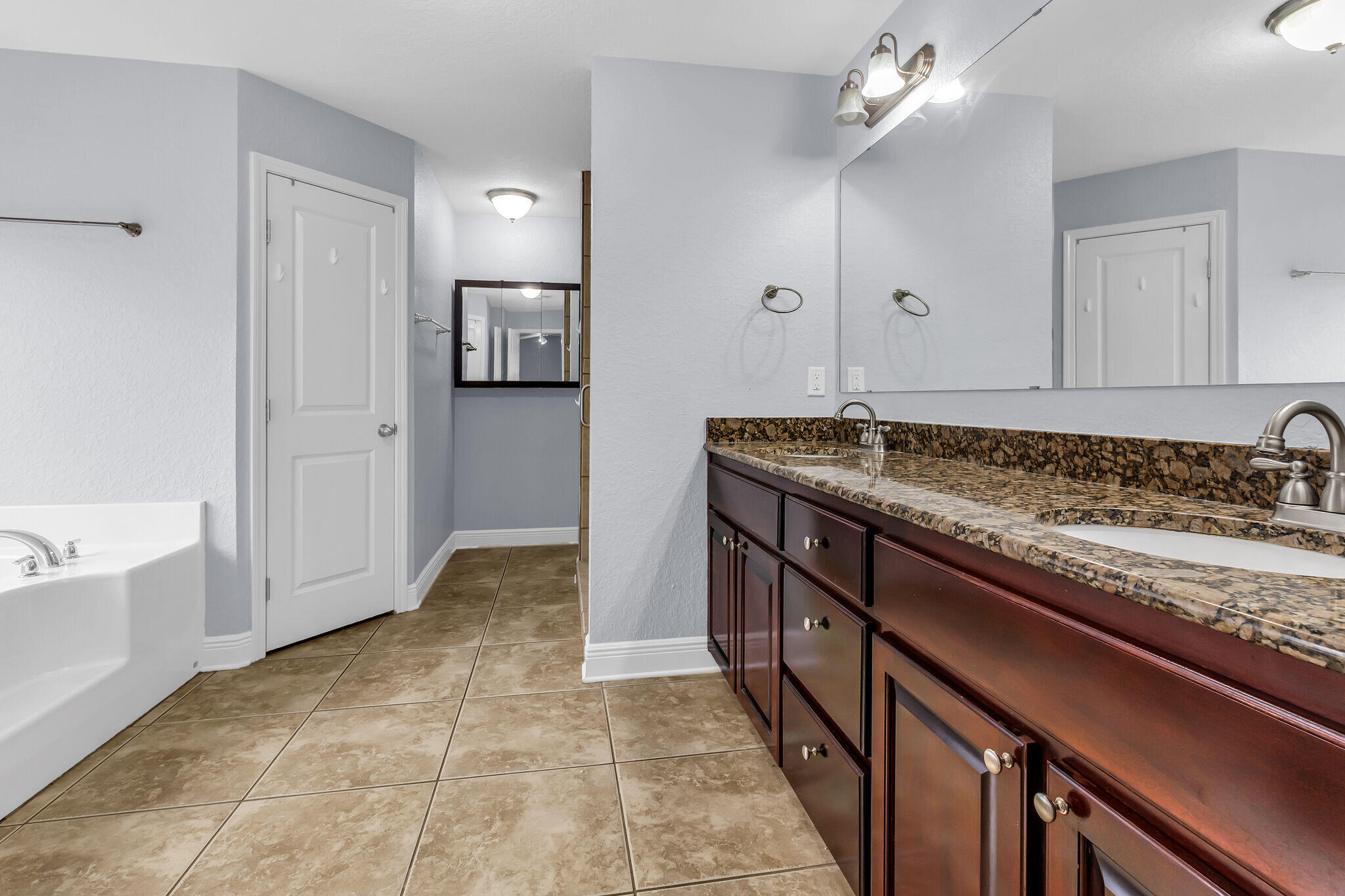 6181 Hummingbird Lane Crestview, FL 32536 - Photo 29 of 46 a spacious bathroom with a granite countertop sink a mirror and shower