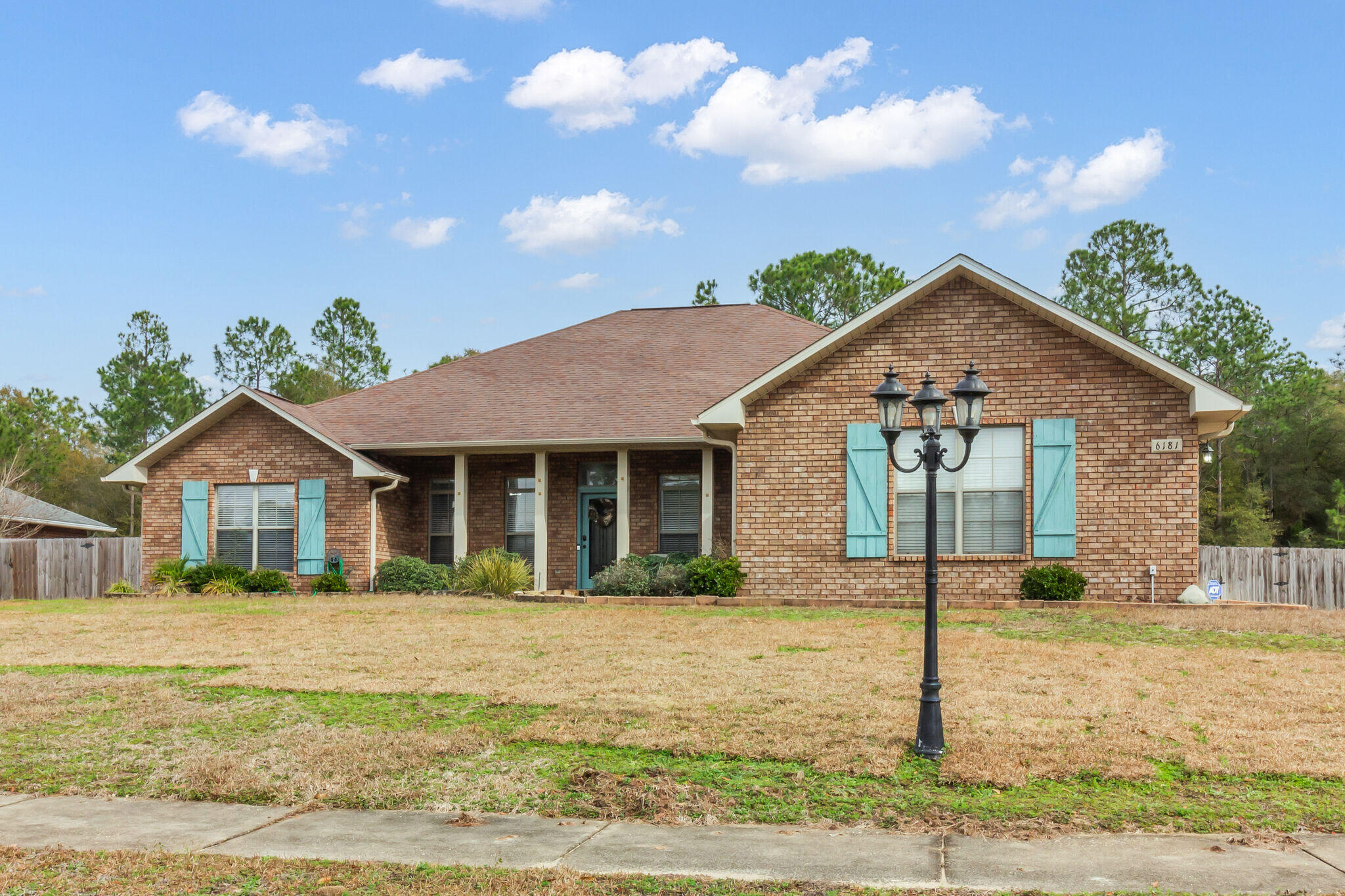 6181 Hummingbird Lane Crestview, FL 32536 - Photo 3 of 46 a front view of a house with garden