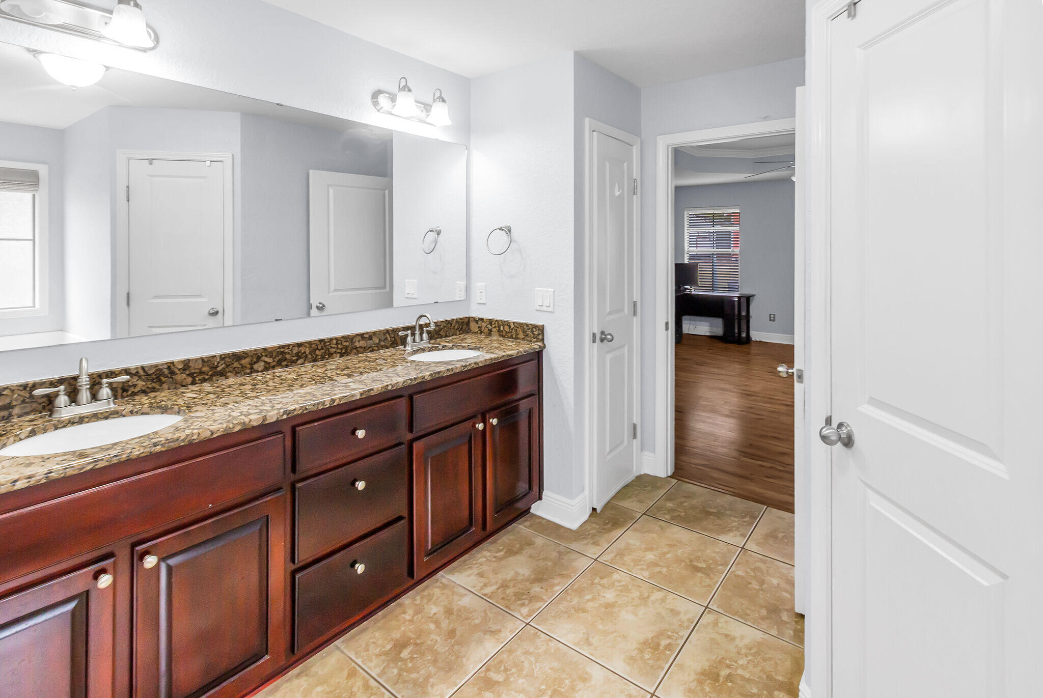 6181 Hummingbird Lane Crestview, FL 32536 - Photo 31 of 46 a spacious bathroom with a granite countertop sink and a mirror