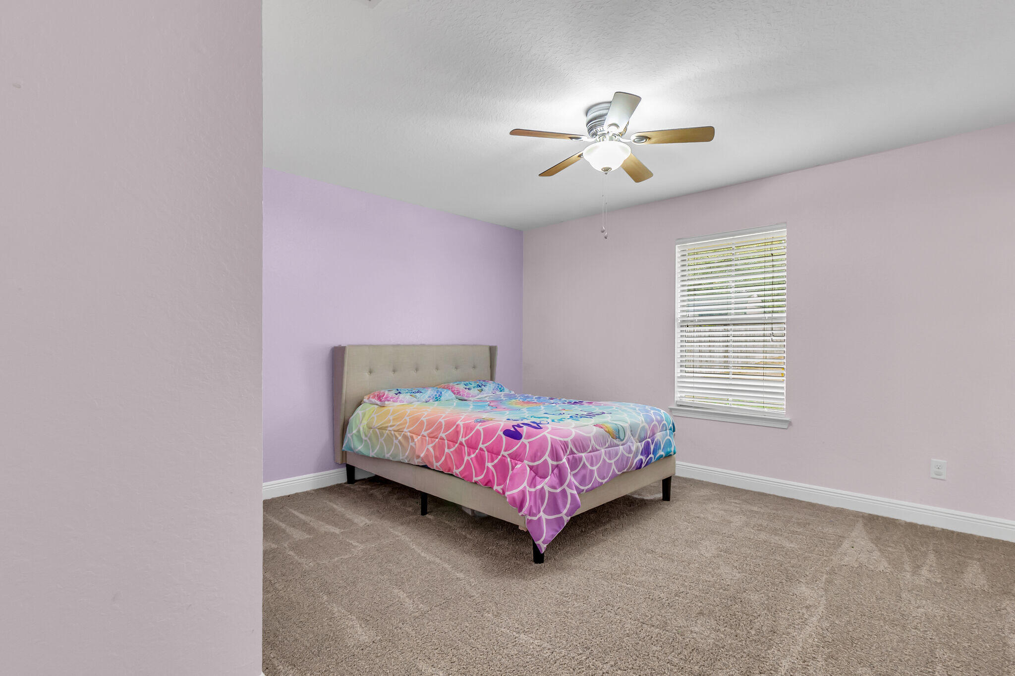 6181 Hummingbird Lane Crestview, FL 32536 - Photo 37 of 46 a bedroom with a bed and a chandelier