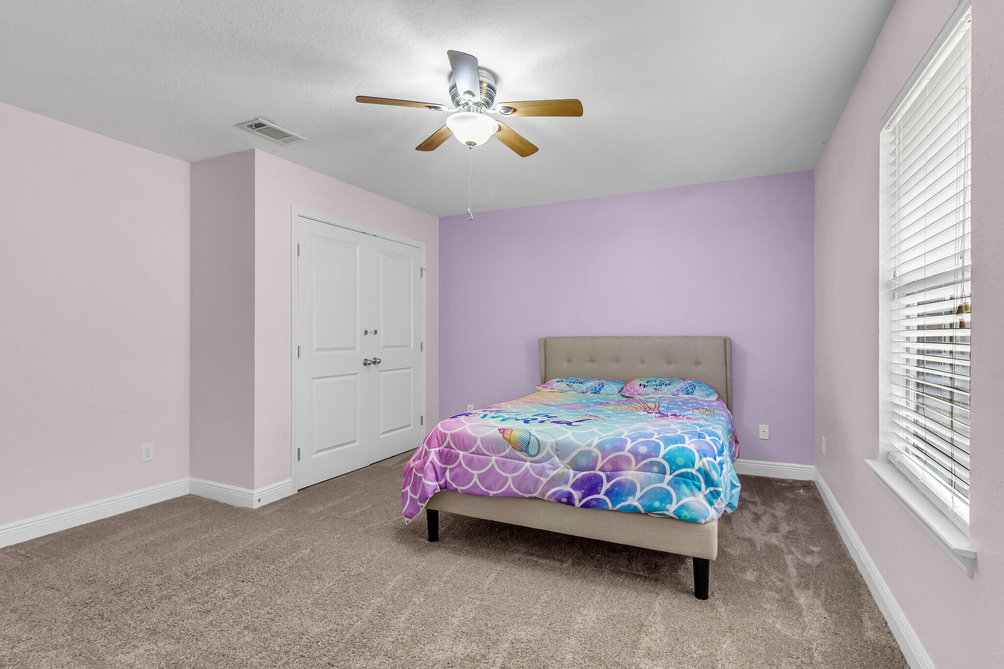 6181 Hummingbird Lane Crestview, FL 32536 - Photo 38 of 46 a bedroom with a bed and a chandelier