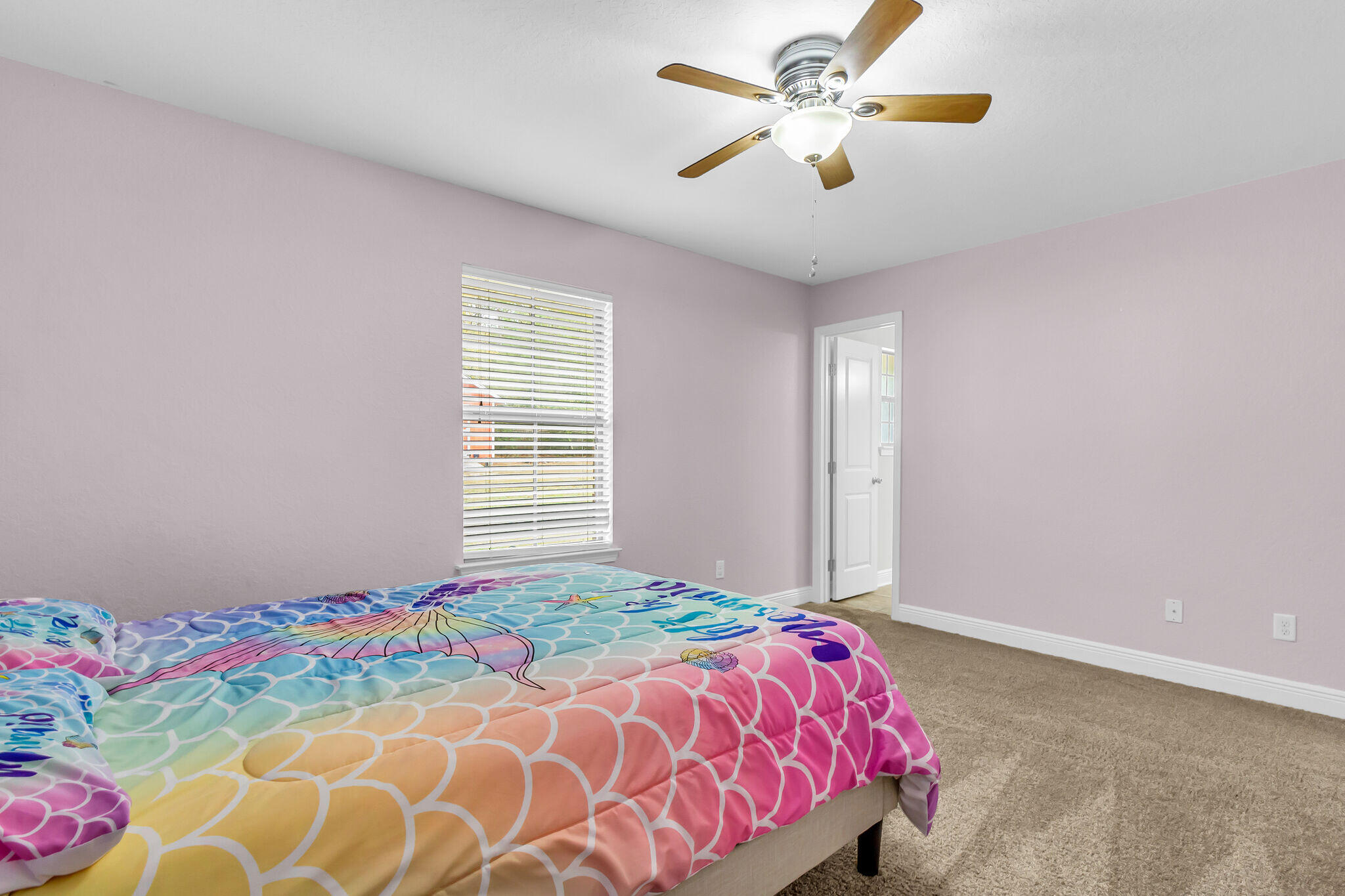 6181 Hummingbird Lane Crestview, FL 32536 - Photo 39 of 46 a bedroom with a bed and a chandelier