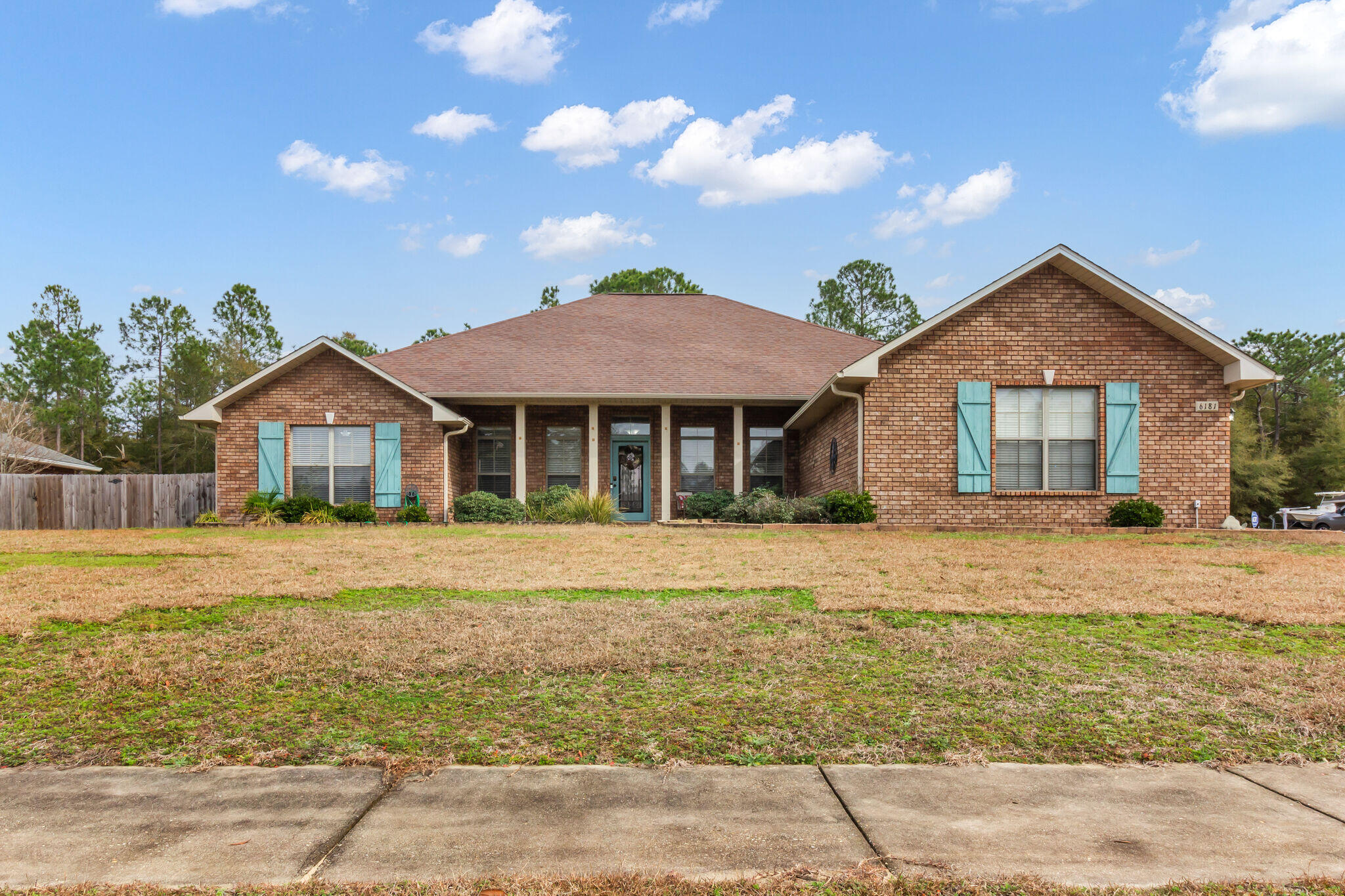 6181 Hummingbird Lane Crestview, FL 32536 - Photo 4 of 46 a front view of a house with a garden and patio