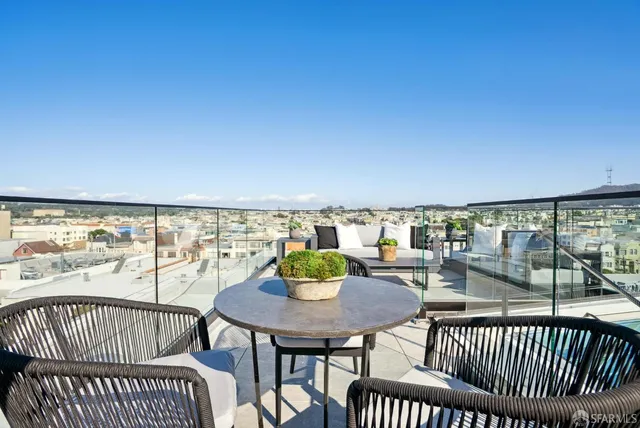 a view of a chairs and table on the deck