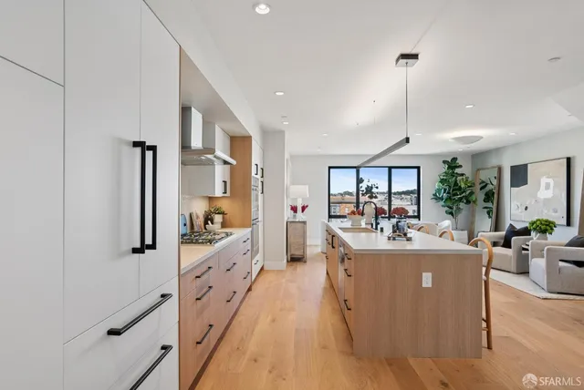 a view of a living room and kitchen with a large window
