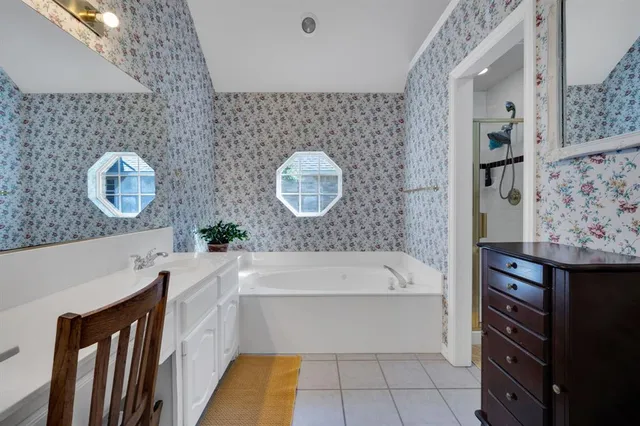 a bathroom with a bathtub sink and mirror