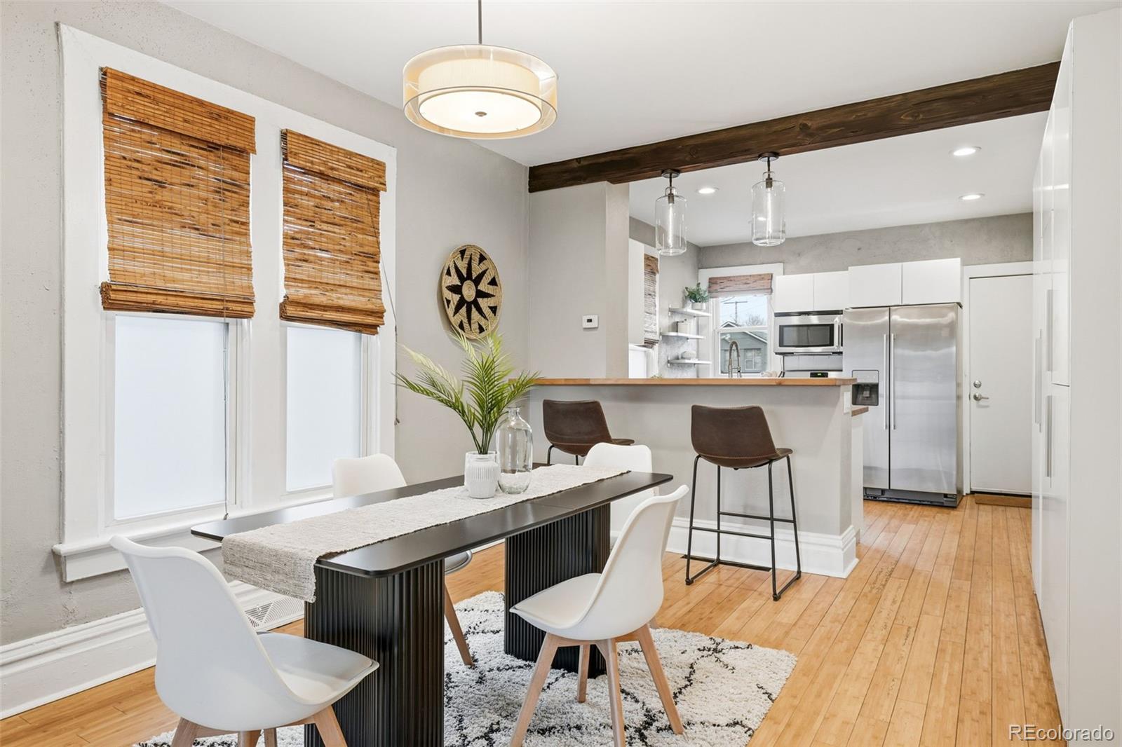 664 Meade Street Denver, CO 80204 - Photo 13 of 32 a dining room with furniture and wooden floor