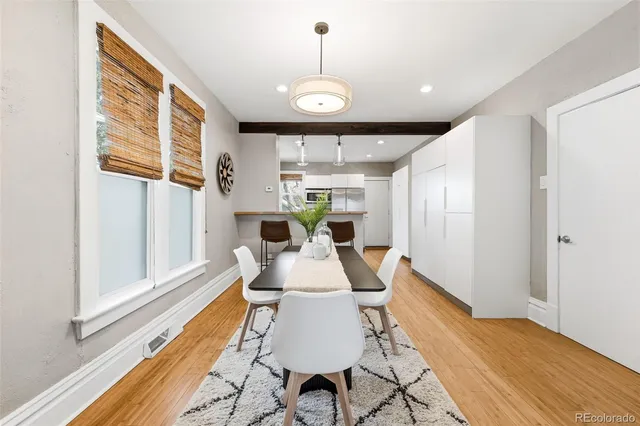 a view of a dining room with furniture window and wooden floor