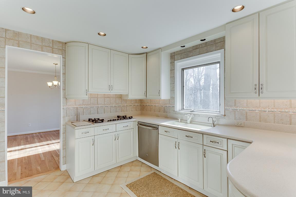 8228 Lakenheath Way Potomac, MD 20854 - Photo 12 of 41 a kitchen with a sink stove and cabinets