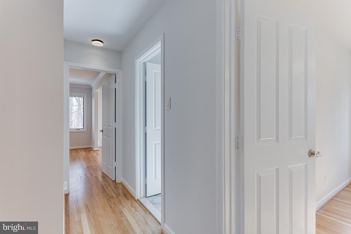8228 Lakenheath Way Potomac, MD 20854 - Photo 16 of 41 a view of a hallway with wooden floor