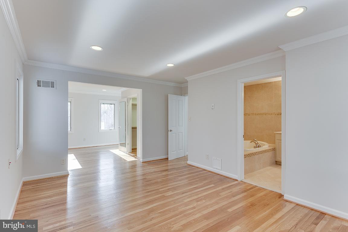 8228 Lakenheath Way Potomac, MD 20854 - Photo 18 of 41 a view of an empty room with wooden floor and a window