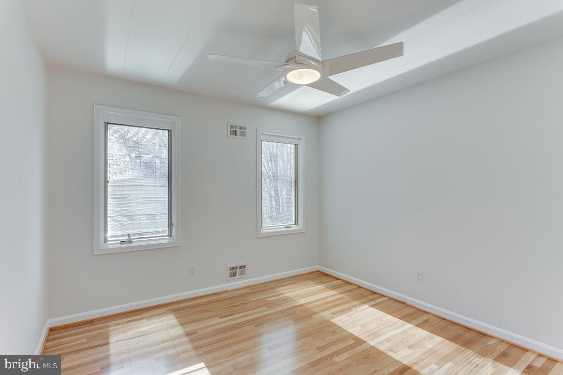 8228 Lakenheath Way Potomac, MD 20854 - Photo 25 of 41 a view of an empty room with wooden floor and a window