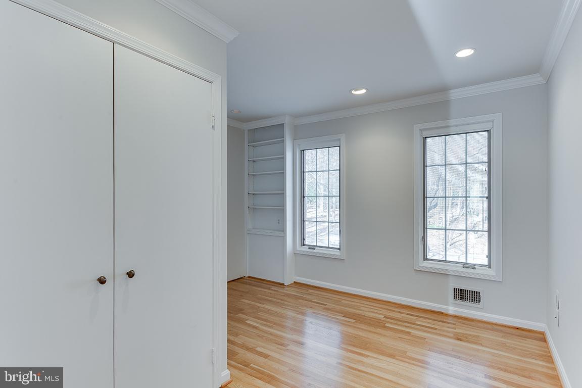 8228 Lakenheath Way Potomac, MD 20854 - Photo 26 of 41 an empty room with wooden floor and windows