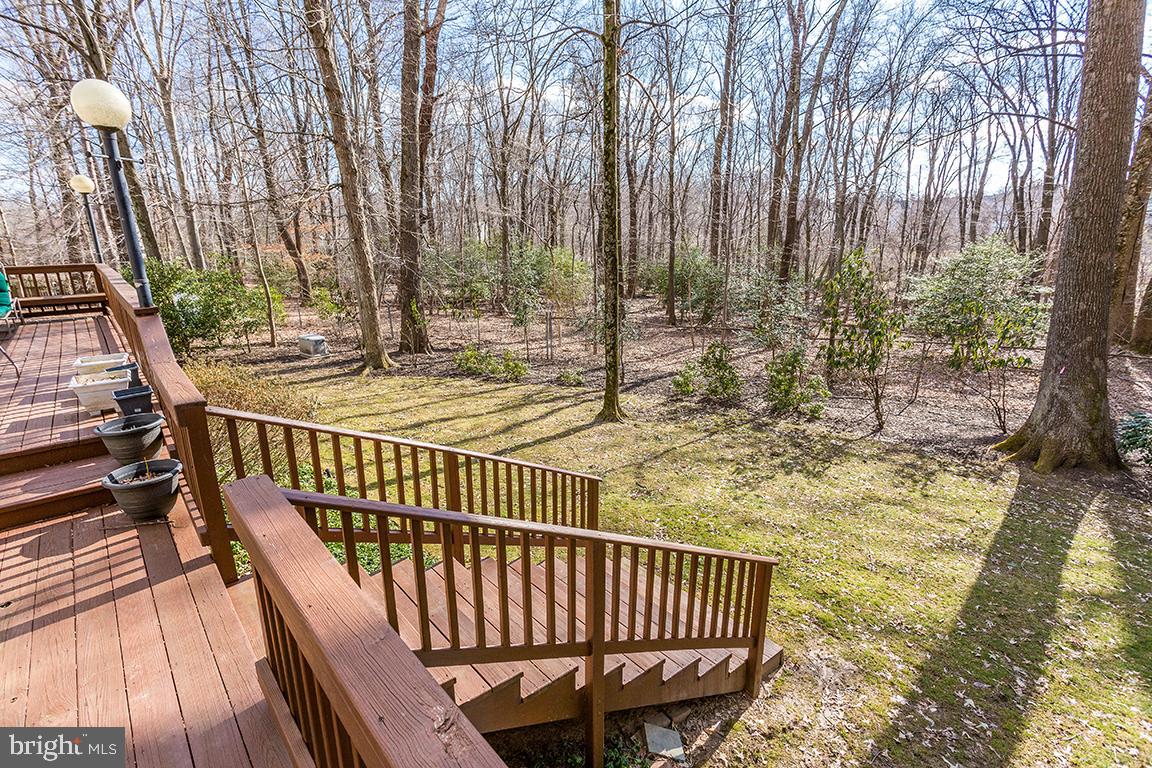 8228 Lakenheath Way Potomac, MD 20854 - Photo 37 of 41 a view of roof deck with wooden floor and outdoor seating
