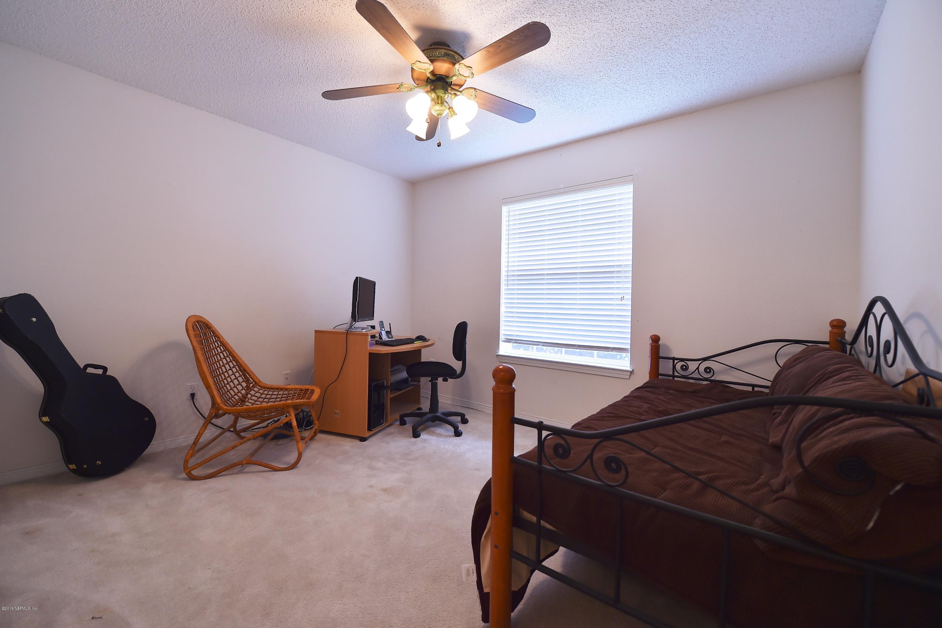 10370 Clayton Mill Road Jacksonville, FL 32221 - Photo 13 of 24 a bed room with a bed and a chair