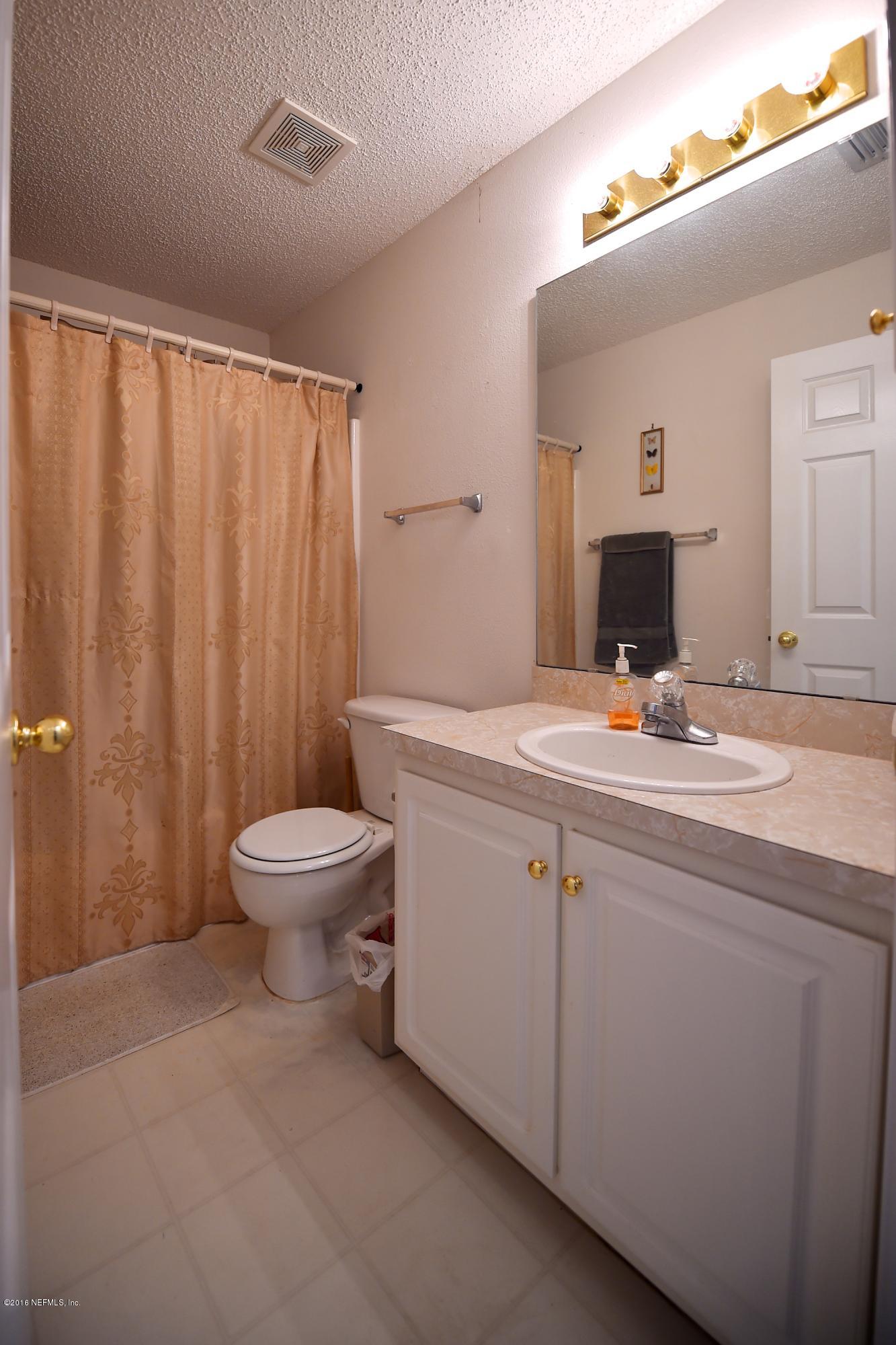 10370 Clayton Mill Road Jacksonville, FL 32221 - Photo 14 of 24 a bathroom with a toilet sink and mirror