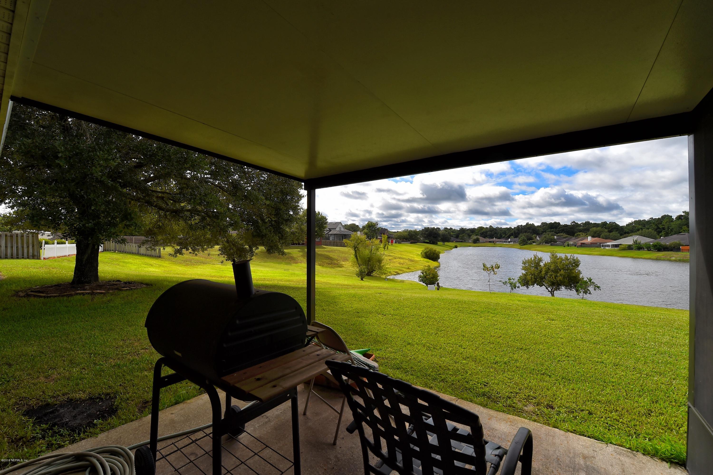 10370 Clayton Mill Road Jacksonville, FL 32221 - Photo 16 of 24 a backyard of a house with table and chairs