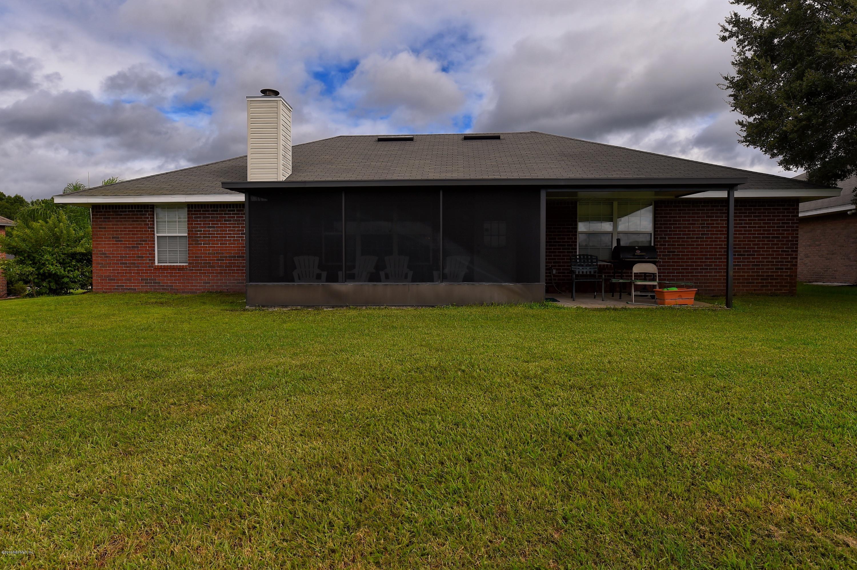 10370 Clayton Mill Road Jacksonville, FL 32221 - Photo 20 of 24 a view of a house with a yard and sitting area