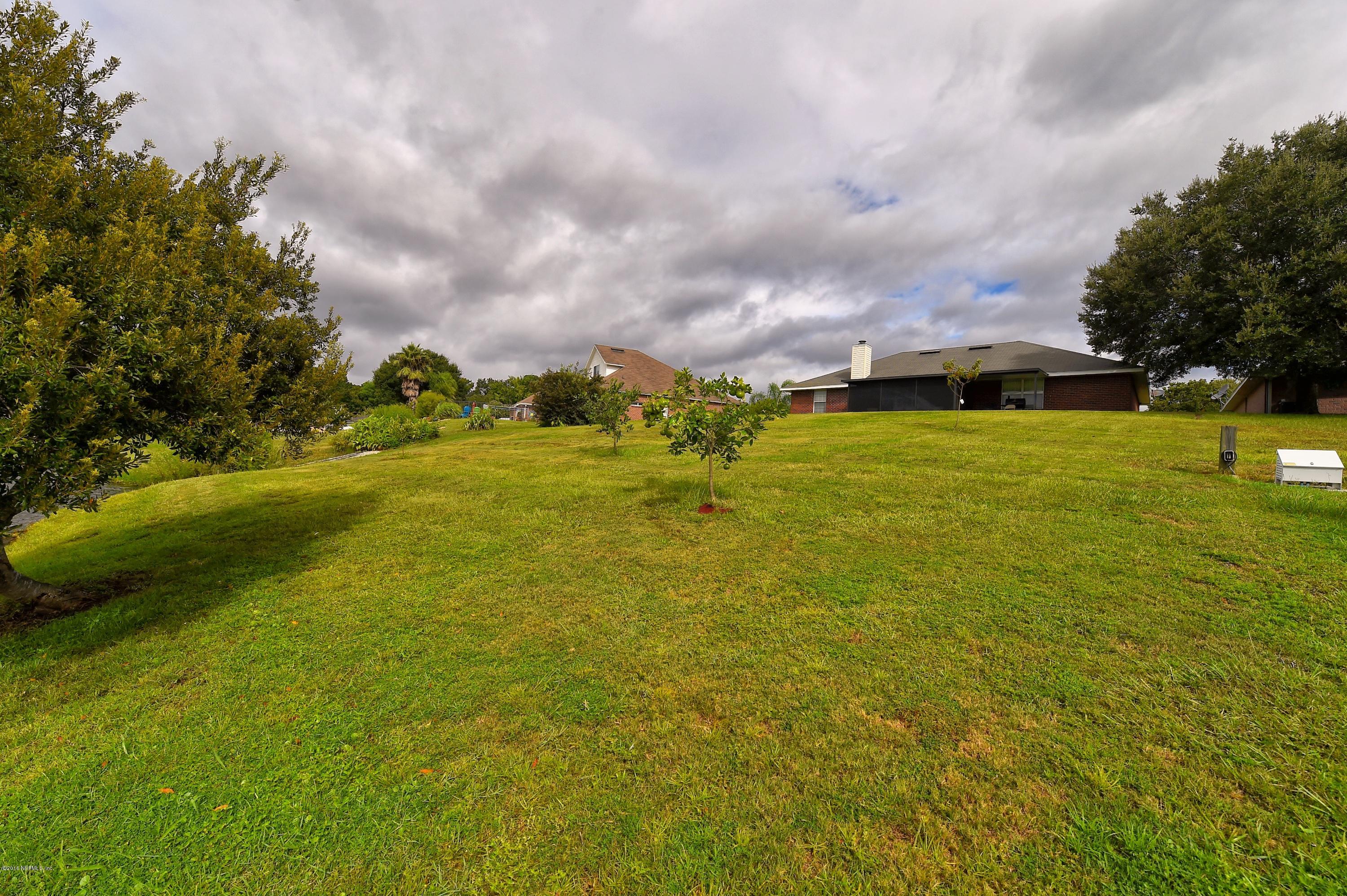 10370 Clayton Mill Road Jacksonville, FL 32221 - Photo 21 of 24 a view of a big yard with an outdoor space and seating area