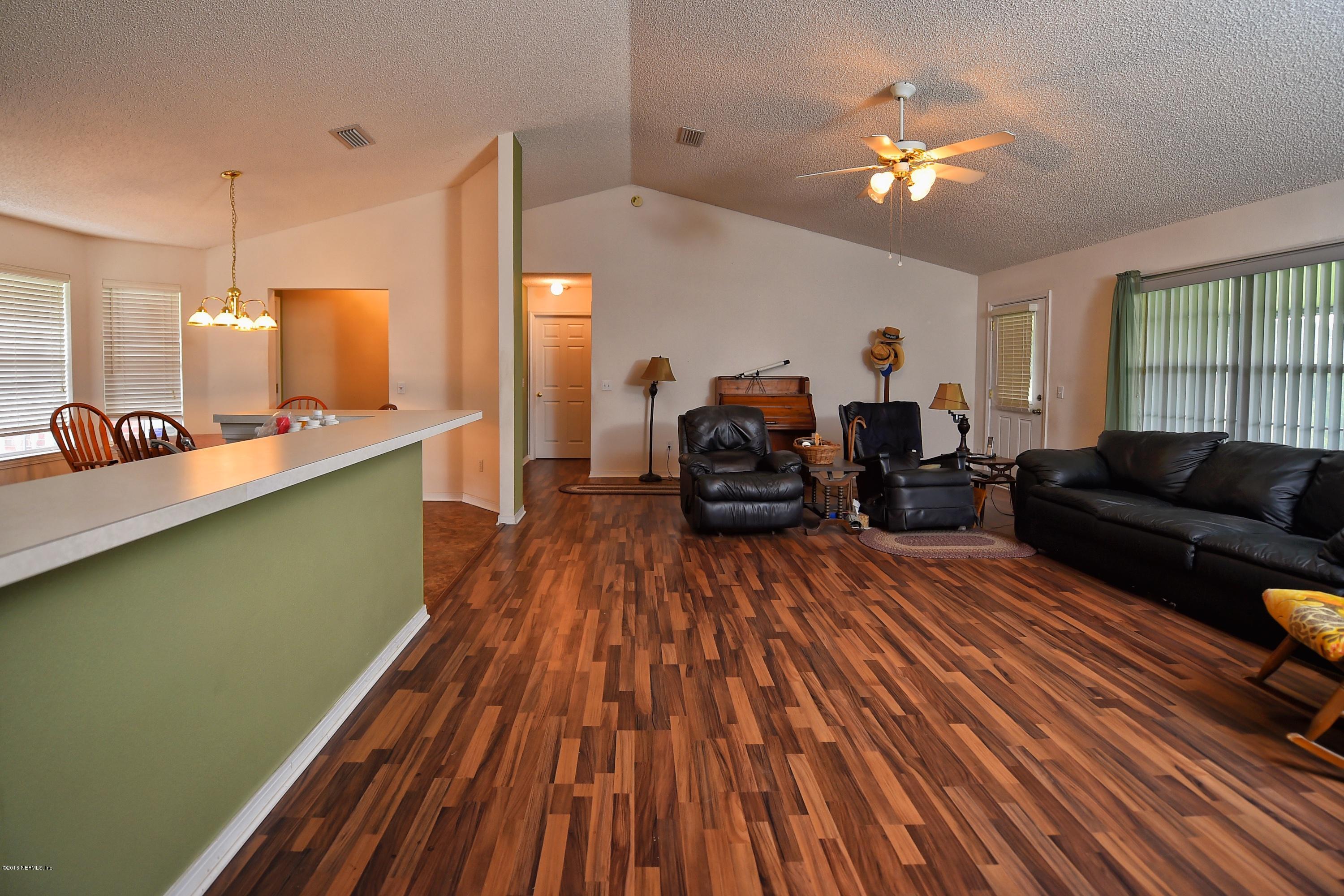 10370 Clayton Mill Road Jacksonville, FL 32221 - Photo 4 of 24 a living room with furniture and a wooden floor