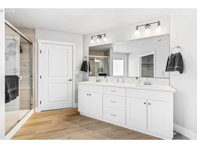 a bathroom with a sink a light fixture a vanity and a mirror