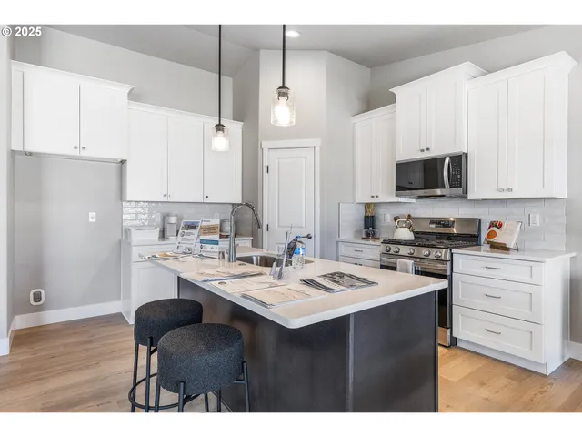 a kitchen with a sink stove and microwave
