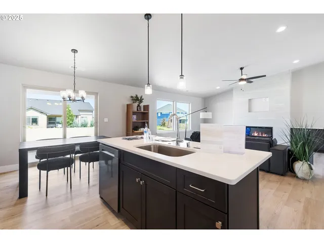 a kitchen with a sink a center island and cabinets