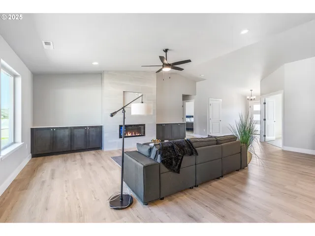 a living room with furniture and wooden floor